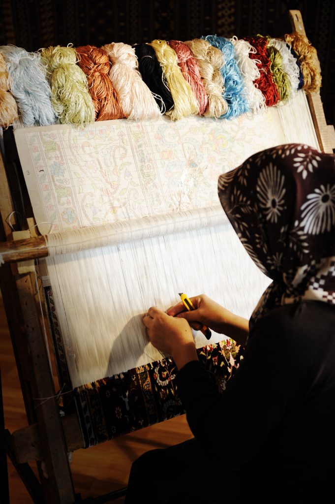 woman-weaving-a-carpet
